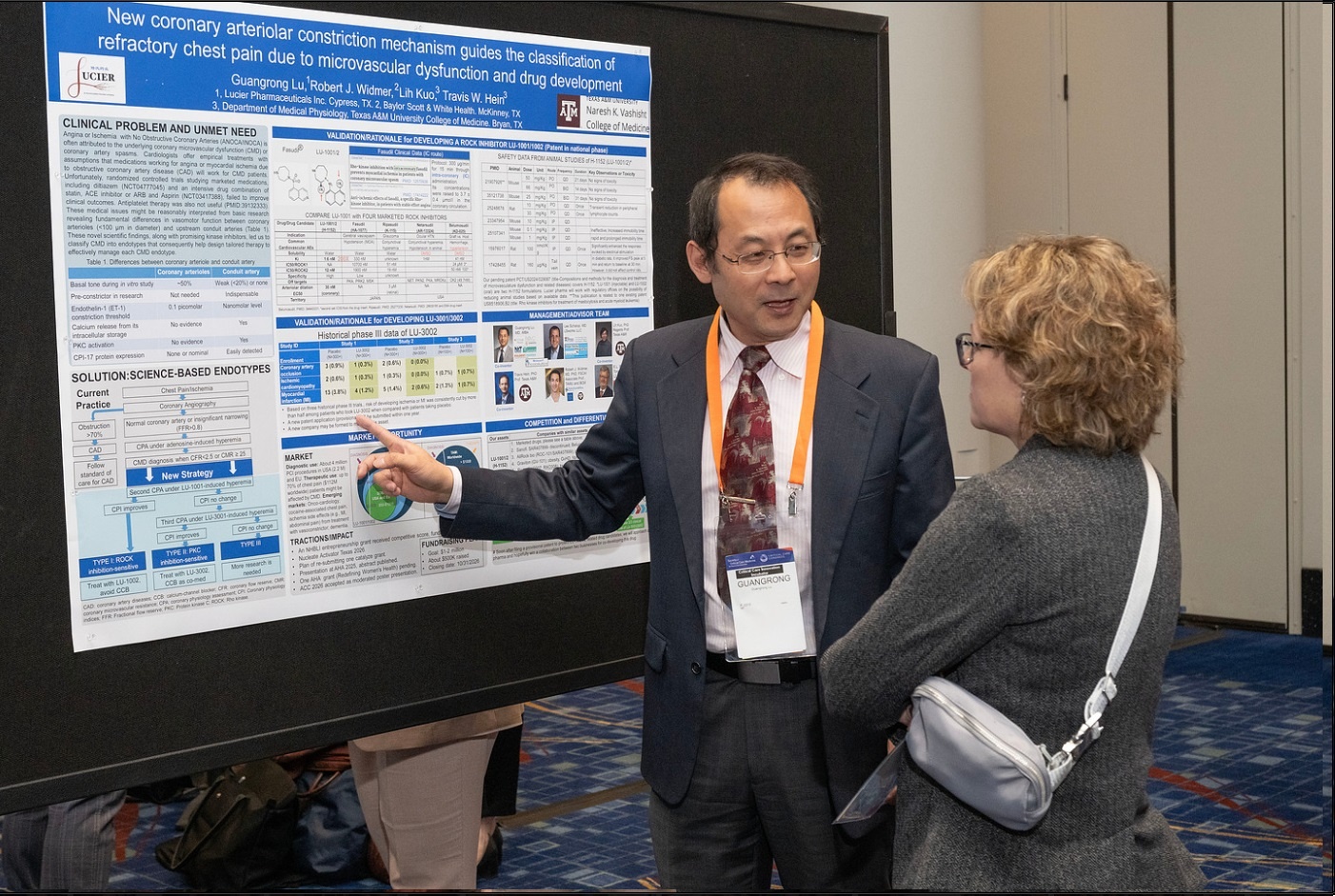 Dr. Guangrong Lu discusses Lucier’s research poster with an attendee at SCCM Discovery.